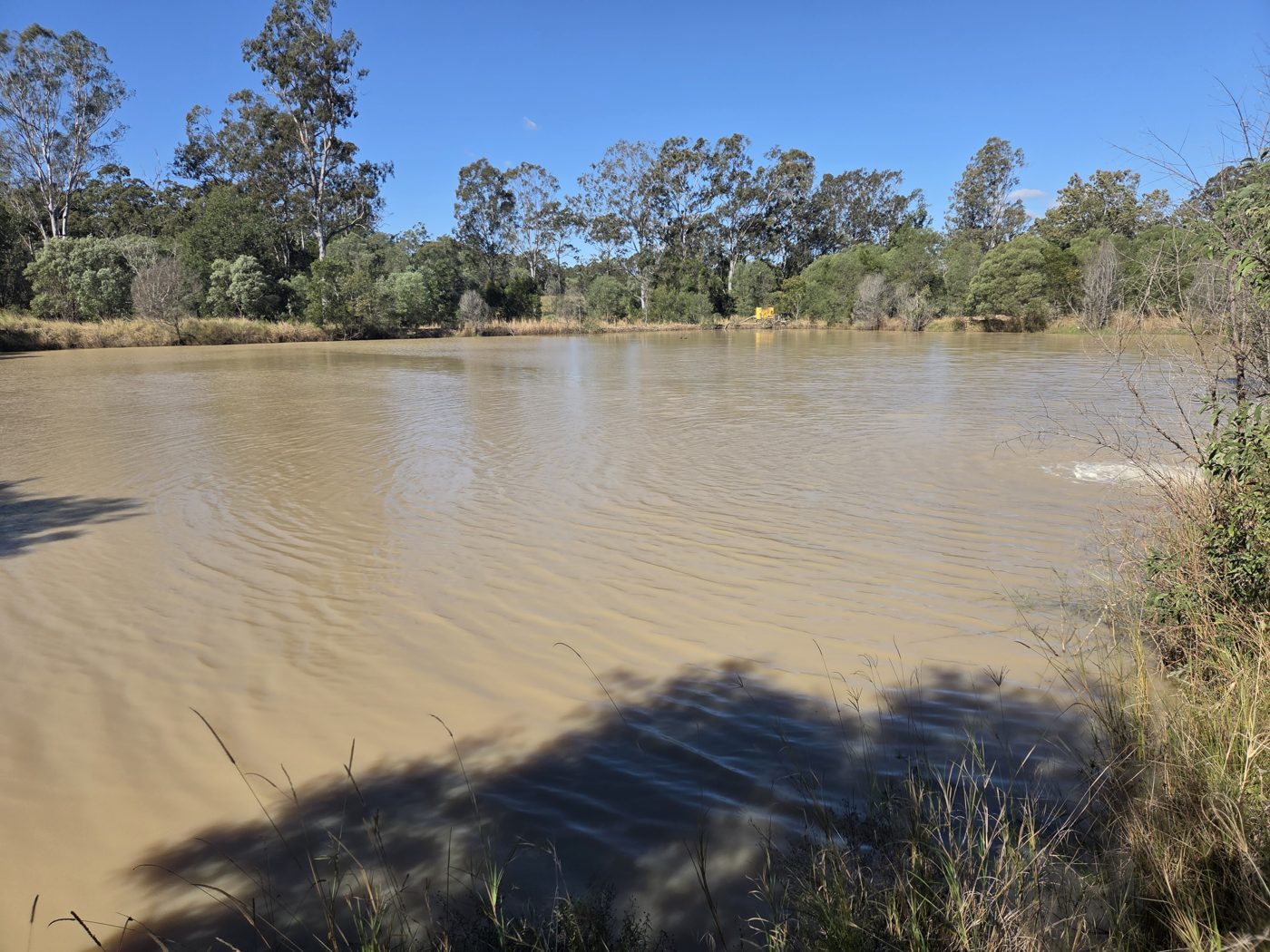 Settling pond with a pump in the background
